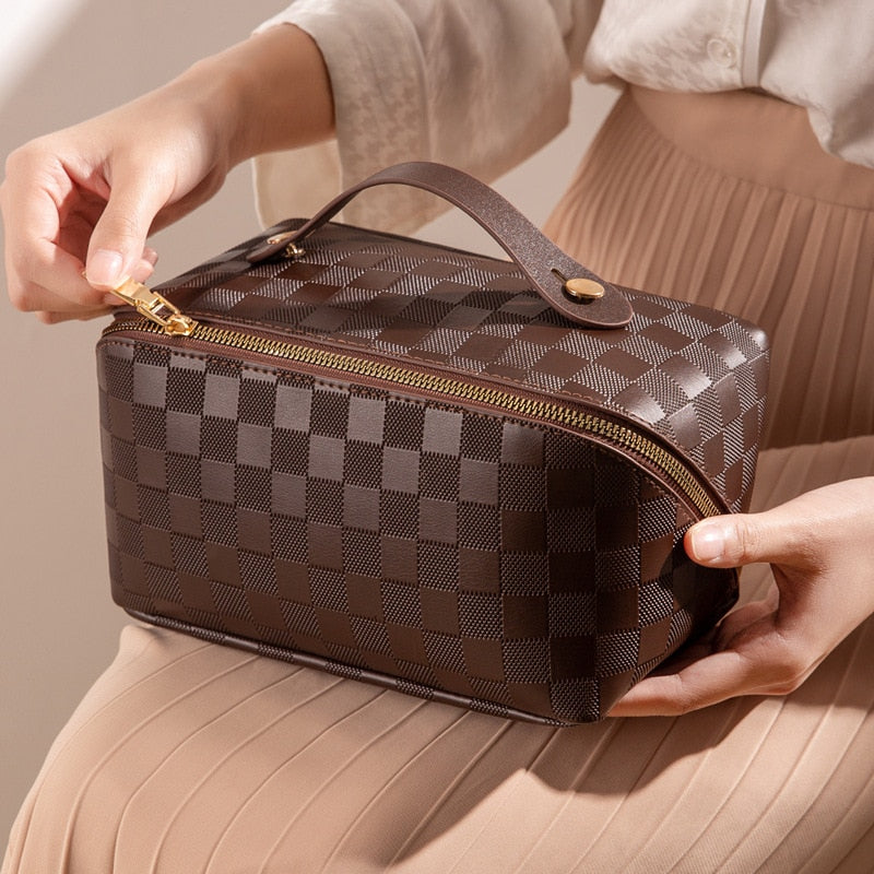 Cosmetic bag in check pattern made of PU leather with carrying handle